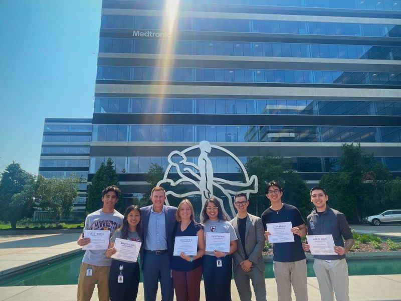 Suvu and teammates outside Medtronic holding their hackathon certificates